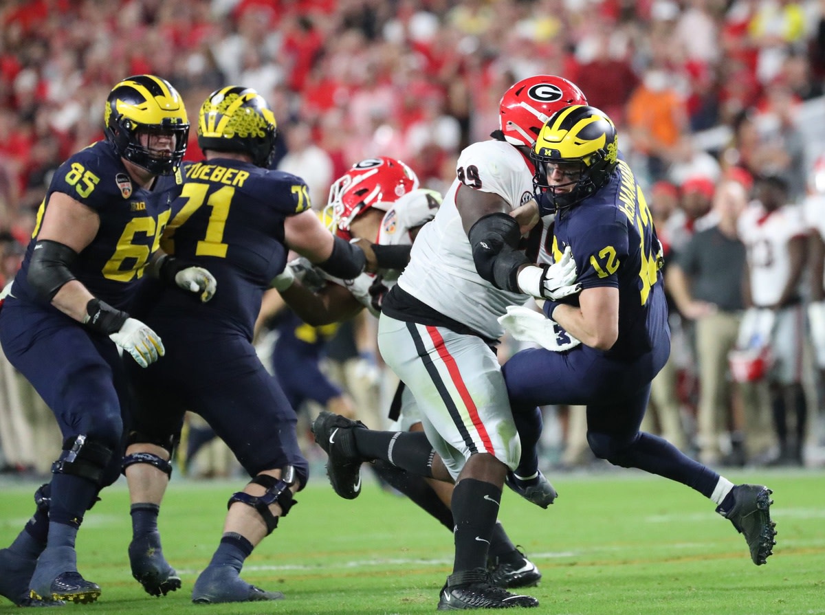 Michigan quarterback Cade McNamara is knocked down by Georgia defensive lineman Jordan Davis Kirthmon F. Dozier / USA TODAY NETWORK